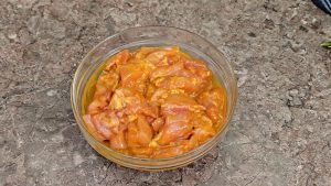 Diced chicken marinating for chicken satay skewers